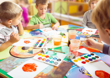 Students in a classroom working on art